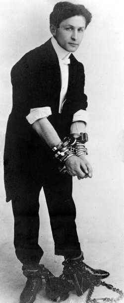 Harry Houdini in handcuffs and shackles